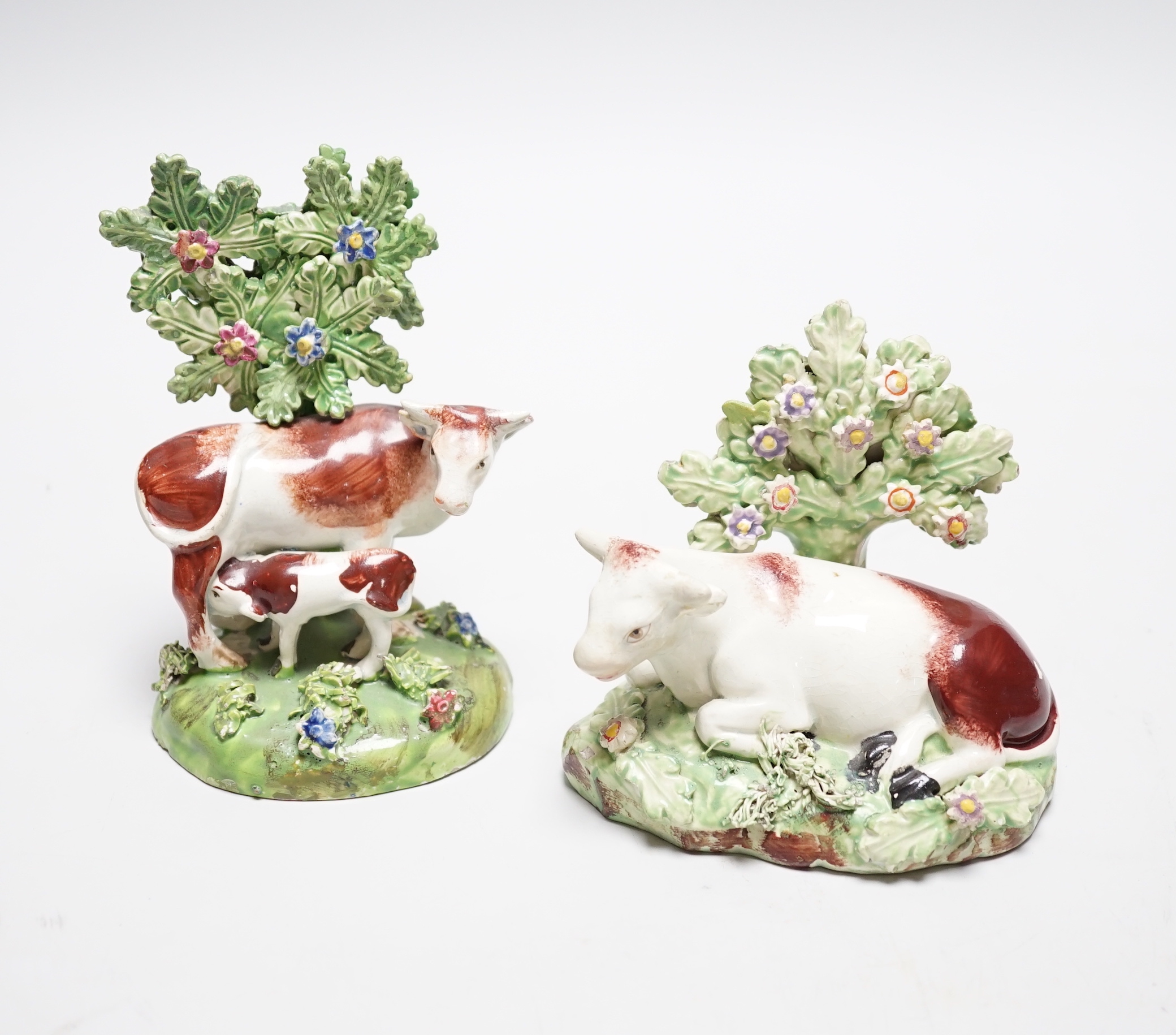 Two Staffordshire pearlware cow groups, c.1820-30, tallest 12cm